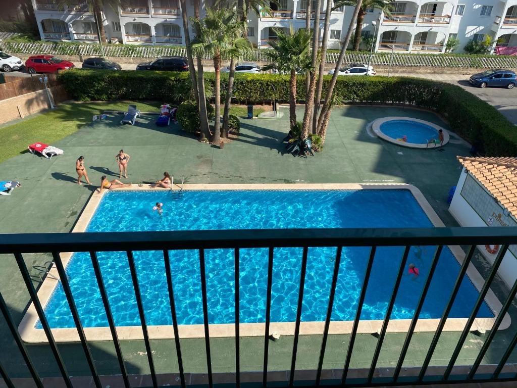 an overhead view of a swimming pool with people in it at Apartment Alcudia Beach in Port d'Alcudia