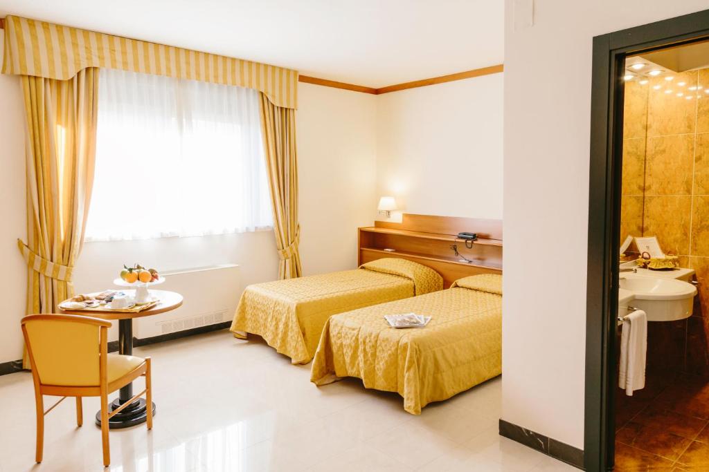 Postel nebo postele na pokoji v ubytování Hotel Residence Federiciano