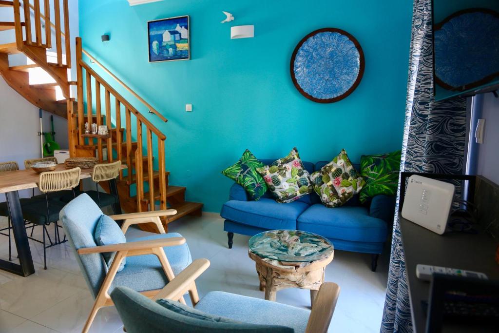 a blue living room with a blue couch and stairs at Casa Anthos in Chania