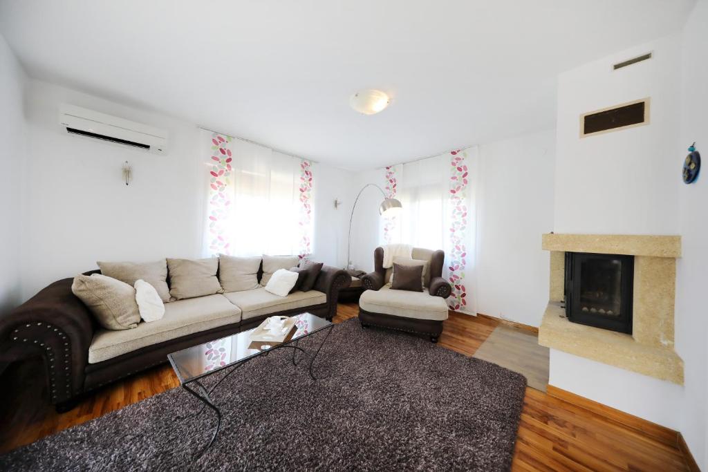 a living room with a couch and a fireplace at Villa Cvita in Povljana