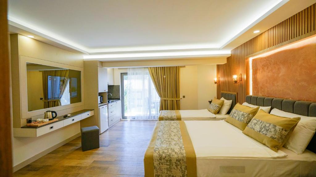 Postel nebo postele na pokoji v ubytování Green Beyza Suites