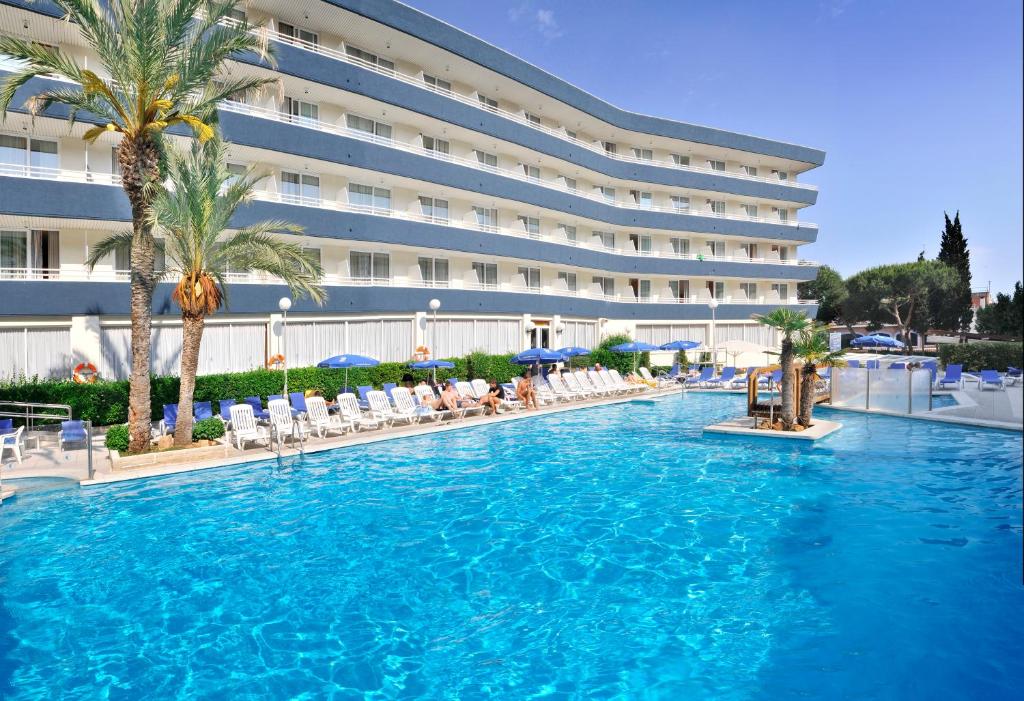 a large swimming pool in front of a hotel at GHT Aquarium & Spa in Lloret de Mar