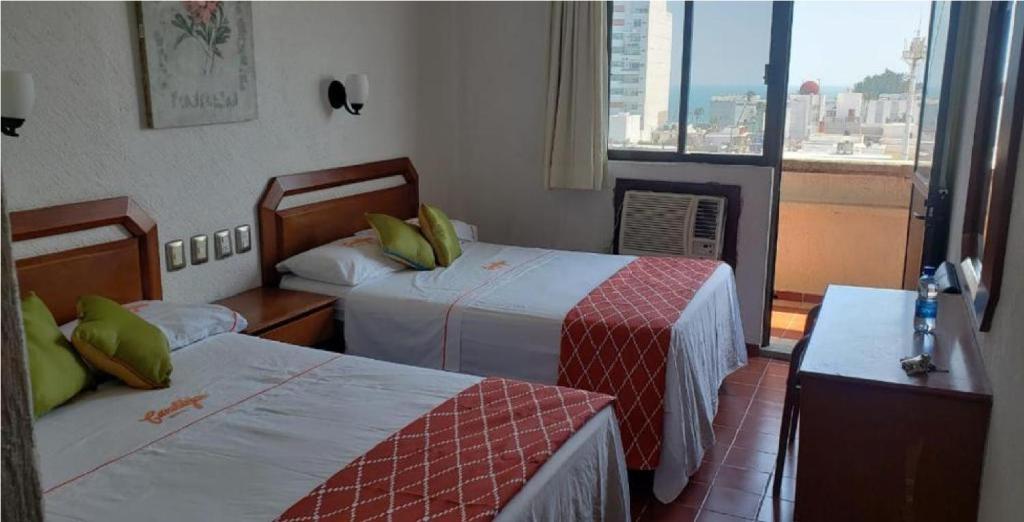 Postel nebo postele na pokoji v ubytování Hotel Candilejas Playa