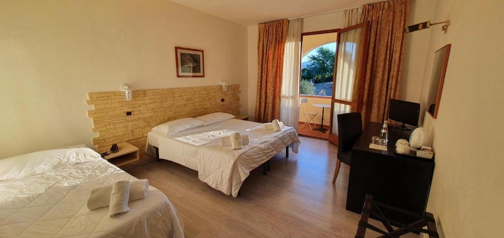 Postel nebo postele na pokoji v ubytování Hotel Carignano