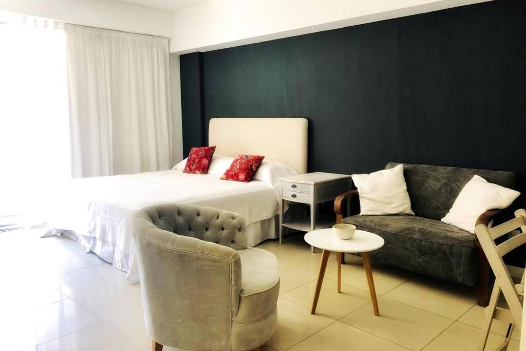 a hotel room with a bed and a couch at Modern Studio between Palermo and Recoleta in Buenos Aires