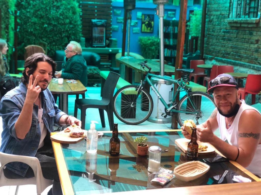 two people sitting at a table in a restaurant at Blue House Youth Hostel in Quito