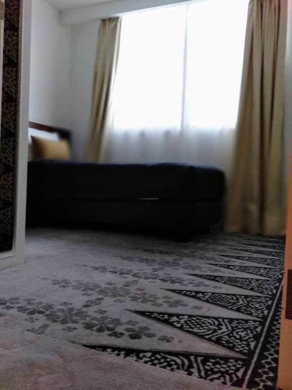 Postel nebo postele na pokoji v ubytování UTM Hotel & Residence