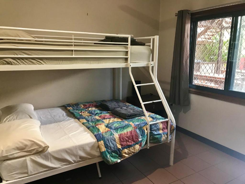 
a bedroom with a bed and a window at Kimberley Travellers Lodge - Broome YHA in Broome
