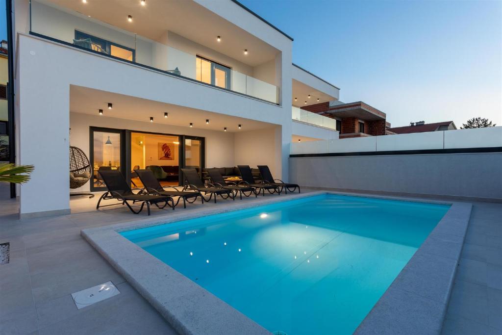 a swimming pool in the backyard of a house at Villa Manhattan in Dobrinj