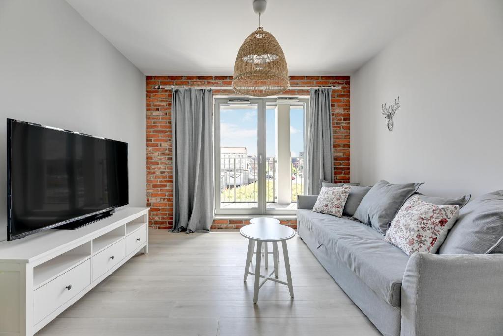 Telewizja i/lub zestaw kina domowego w obiekcie GRANO APARTMENTS Gdańsk Old Town SPA & Wellness - GRANO APARTMENTS Gdańsk Residence SPA & Wellness