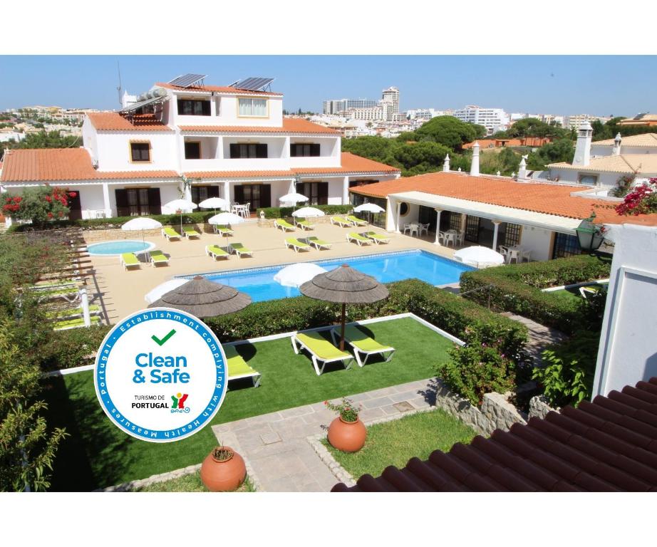 uma fotografia de uma casa com piscina em Balaia Sol Holiday Club em Albufeira