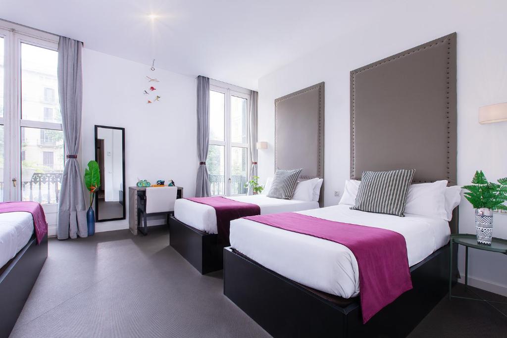 A bed or beds in a room at Amra Barcelona Caspe