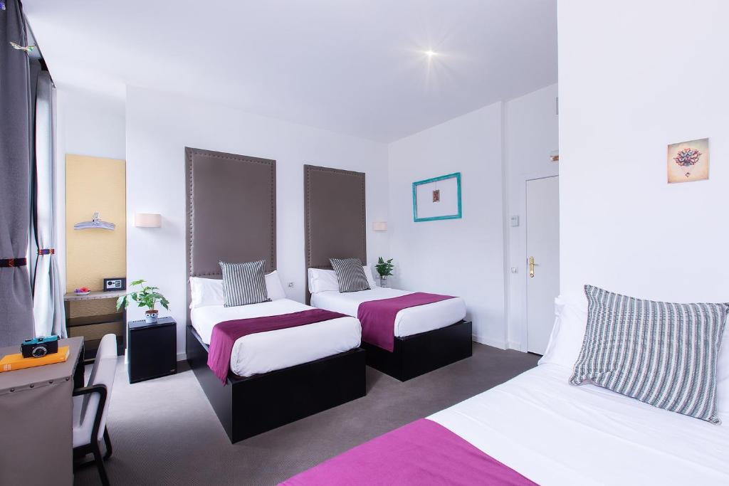 A bed or beds in a room at Amra Barcelona Caspe