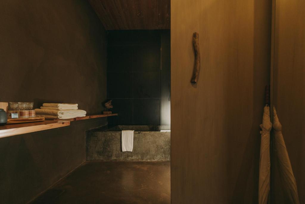 a bathroom with a bath tub and a towel at Santa Barbara Eco-Beach Resort in Ribeira Grande