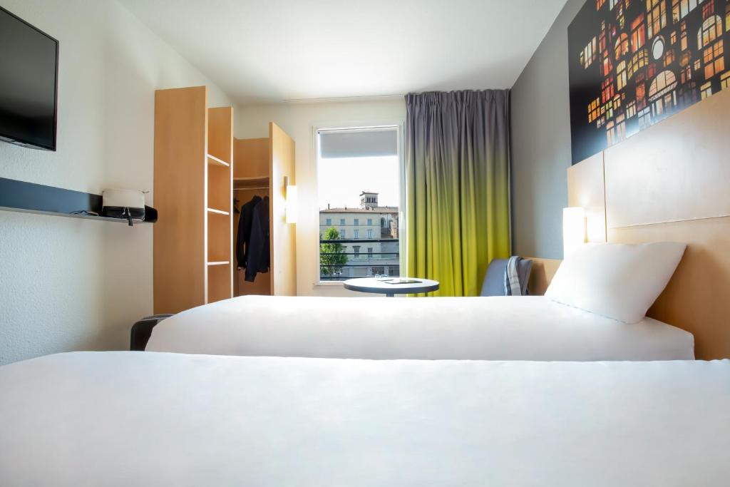 Postel nebo postele na pokoji v ubytování ibis Lyon Sud Vienne Saint-Louis