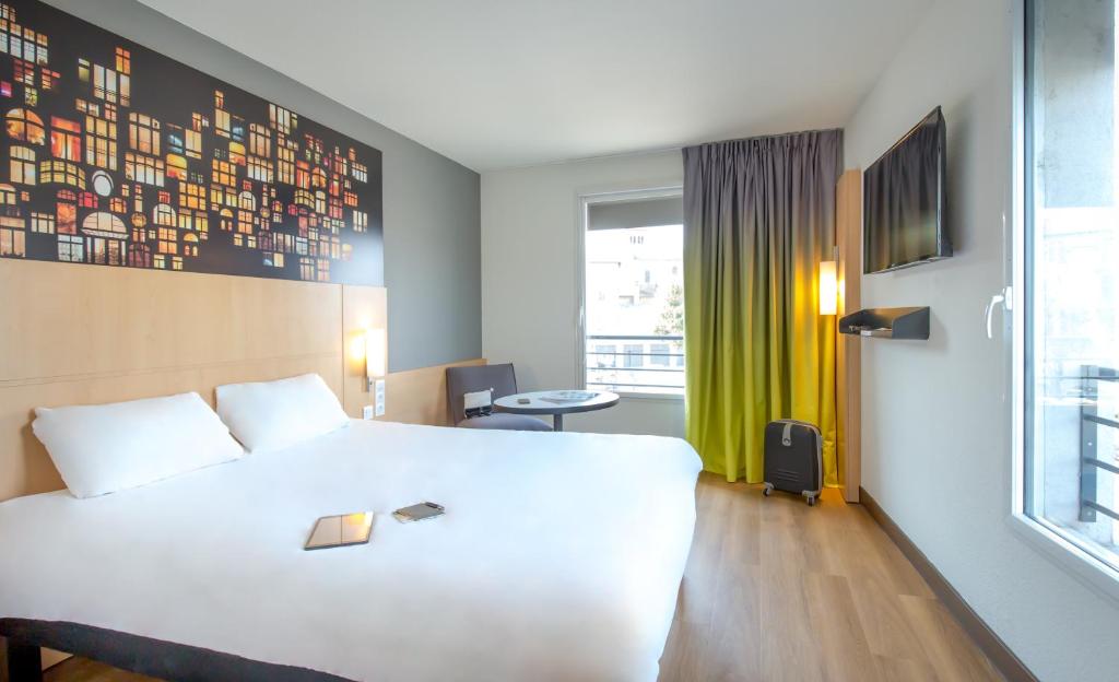Postel nebo postele na pokoji v ubytování ibis Lyon Sud Vienne Saint-Louis