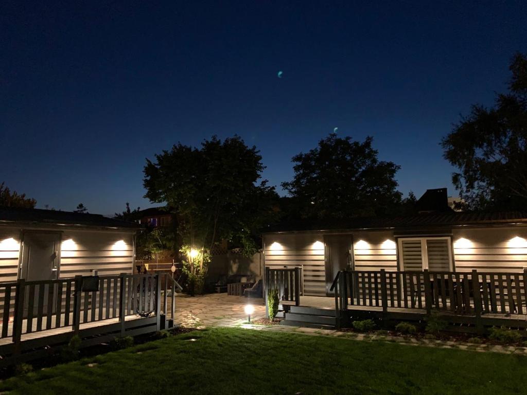 a house lit up at night with lights at Domki nad morzem in Gdańsk