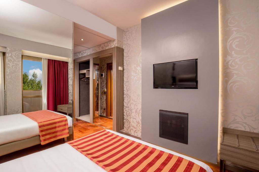 Postel nebo postele na pokoji v ubytování Enea Hotel Pomezia