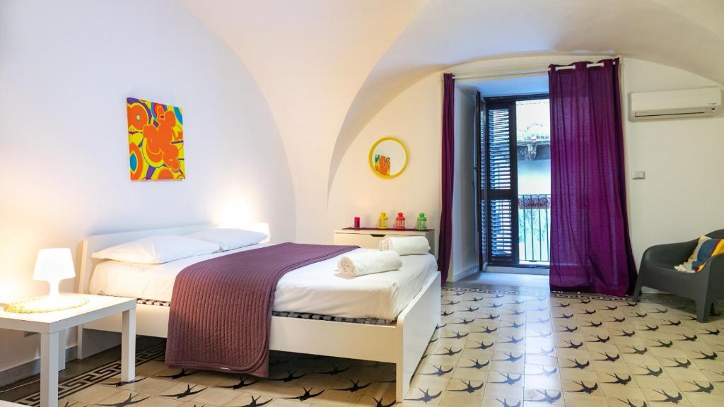 a bedroom with a bed and a table and a chair at The House in Catania