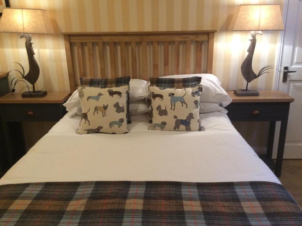 a bedroom with a bed with two lamps on it at Victoria inn in Durham
