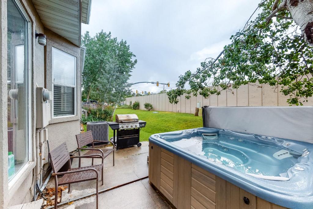 a hot tub sitting on the patio of a house at Skier's Four-Leaf Clover in Cottonwood Heights