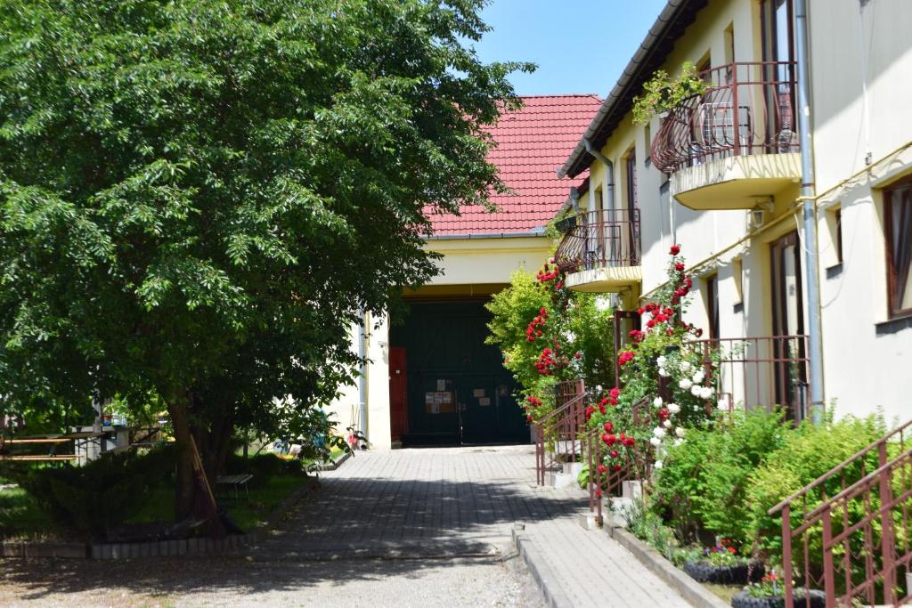 a walkway leading to a building with a door at Pension GreenHouse in Sibiu