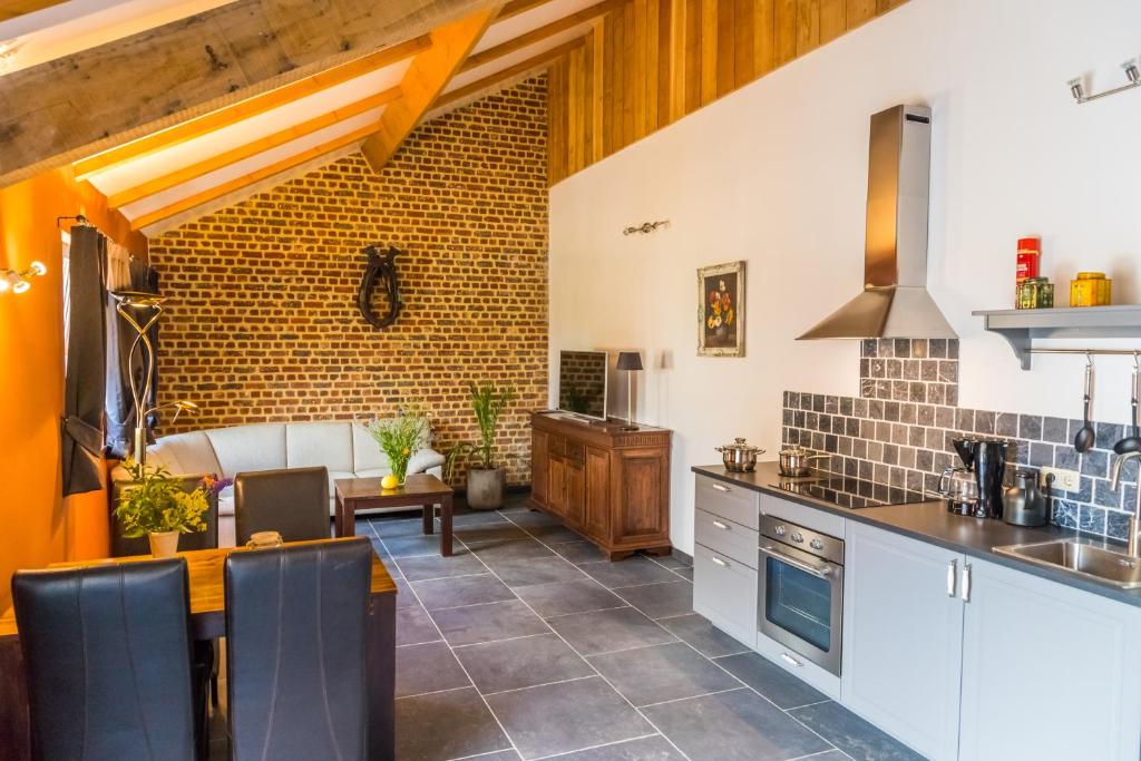 a kitchen with a table and chairs in a room at Valkenhof Schimmert in Schimmert