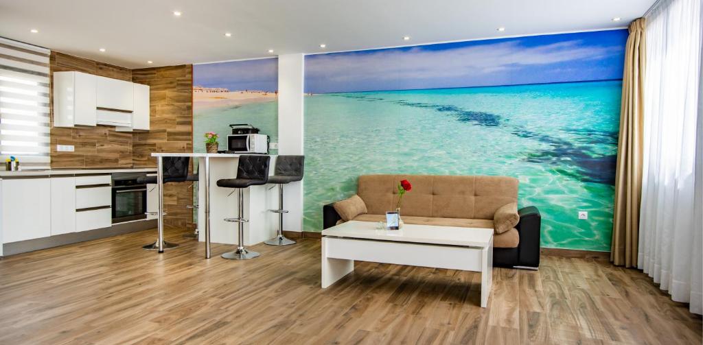 a kitchen and living room with a large painting of the ocean at Loft del Mar 2 Jandia in Playa Jandia