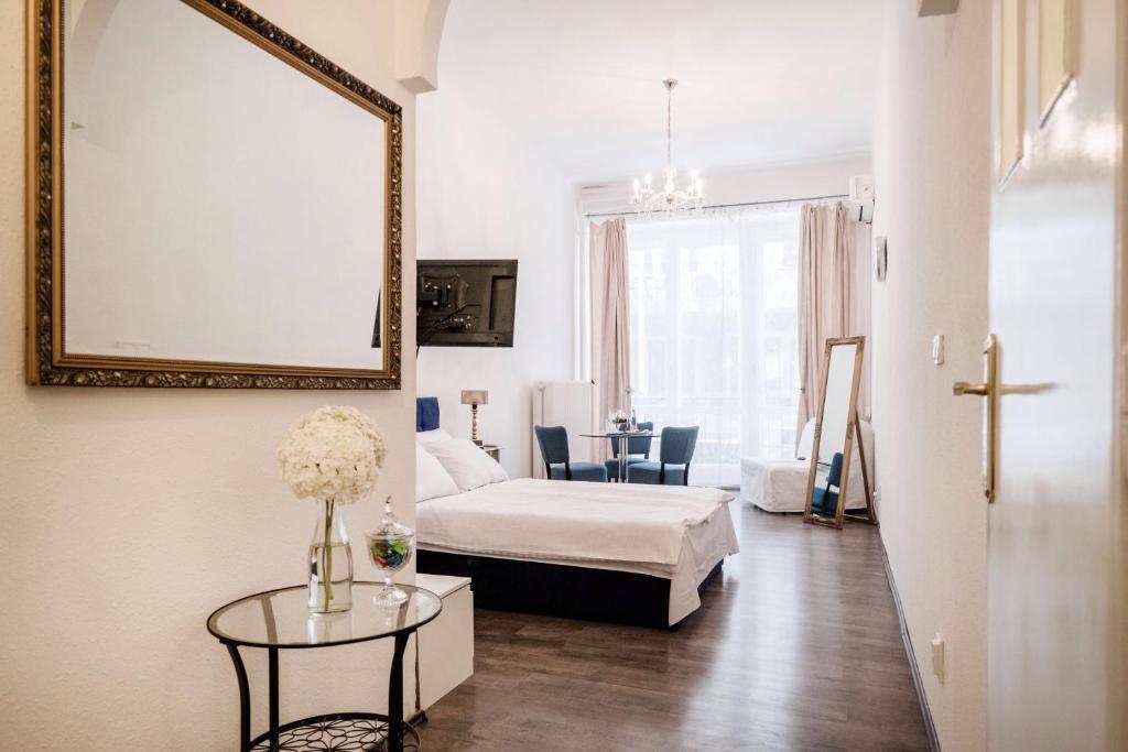 a room with a bed and a table with a mirror at Hungaricum Budapest in Budapest