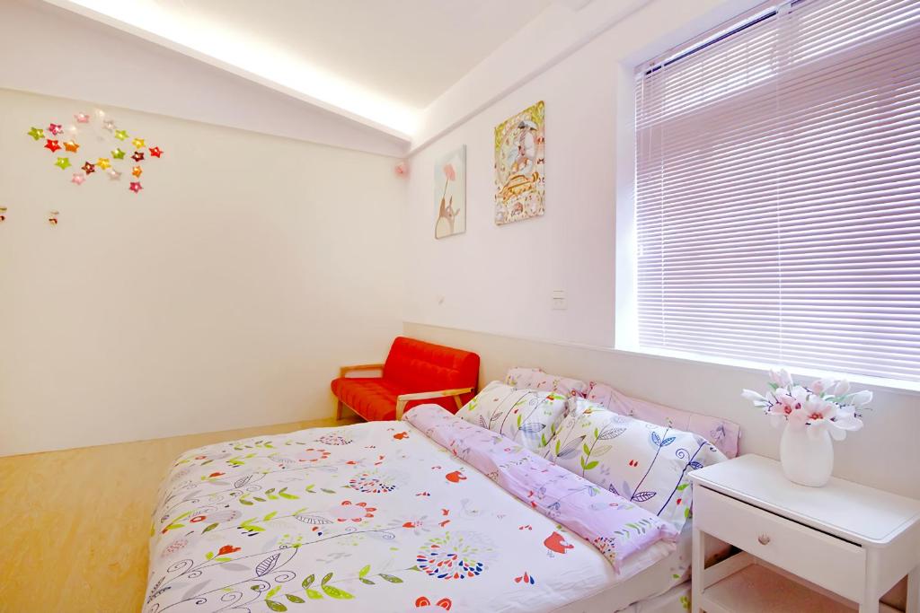 橫山鄉的住宿－內灣彎月民宿，一间卧室配有一张床和一张红色椅子