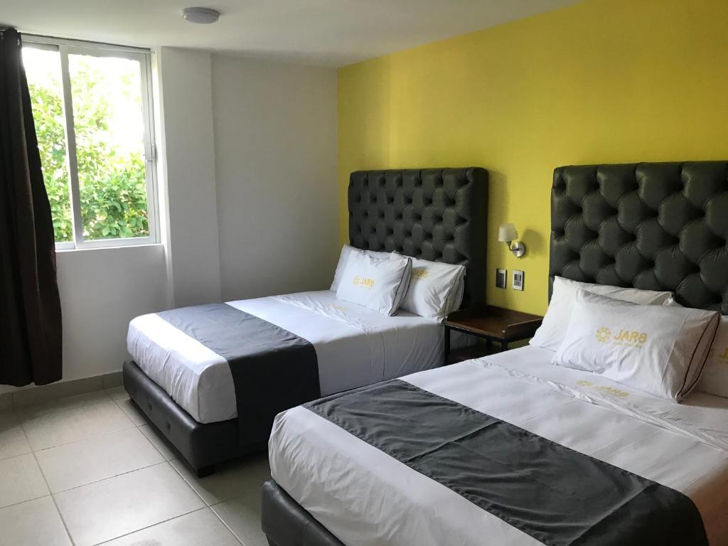Postel nebo postele na pokoji v ubytování Hotel Jar8 Acuario enfrente al Acuario de Veracruz