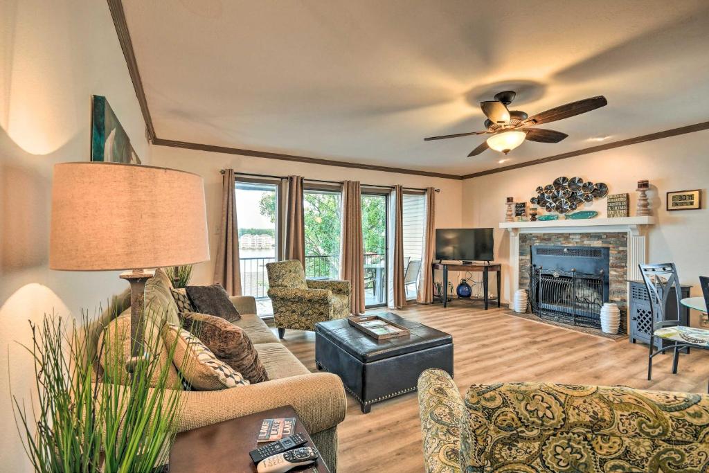 a living room with a couch and a fireplace at Family Resort Condo Near Lake with Boat Slip Access! in Hot Springs