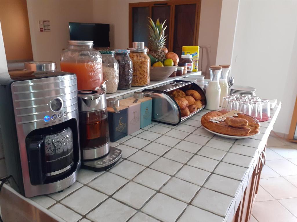 a kitchen counter with a counter top with food on it at Martinique hostel in Sainte-Luce