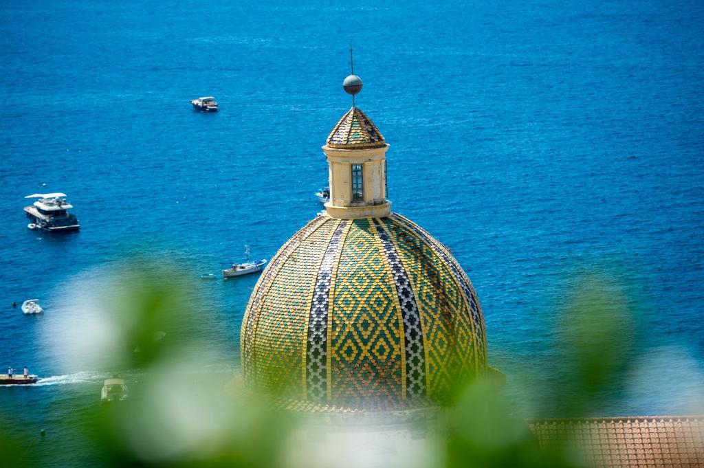 a building with a tower on top of the water at Villa Dalu in Positano