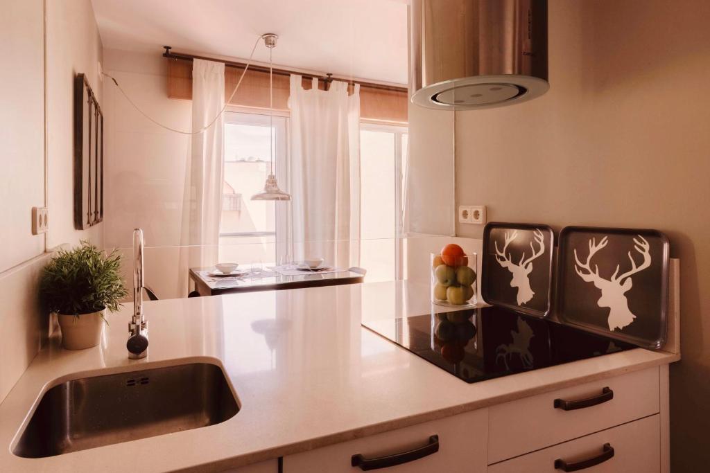 A kitchen or kitchenette at San Amaro Beach Apartment