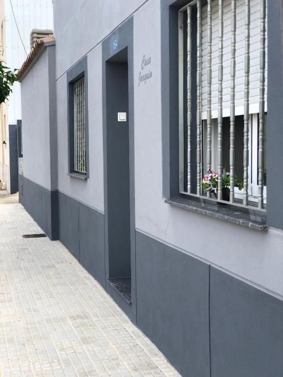 a gray and white building with a window at Caseta del Delta de l'Ebre in Sant Jaume d'Enveja