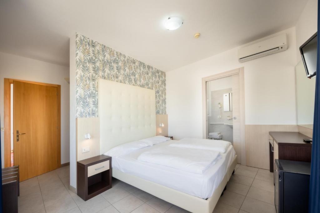 Postel nebo postele na pokoji v ubytování Hotel Gardenia