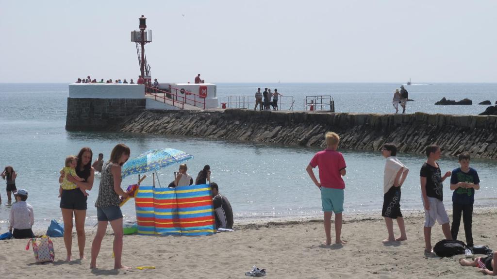 a group of people standing on the beach at Shellseekers Guest House in Looe