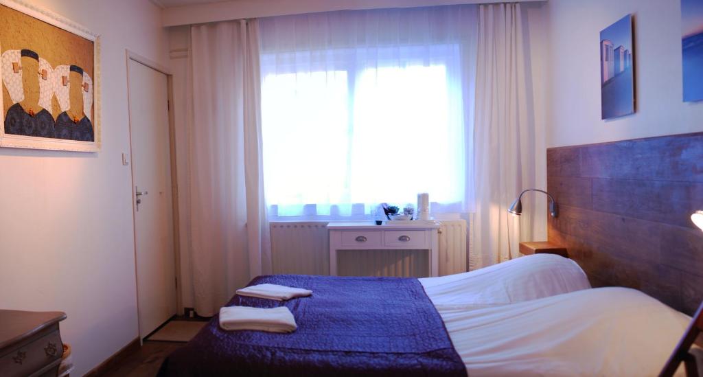 Postel nebo postele na pokoji v ubytování Duinlust Dishoek