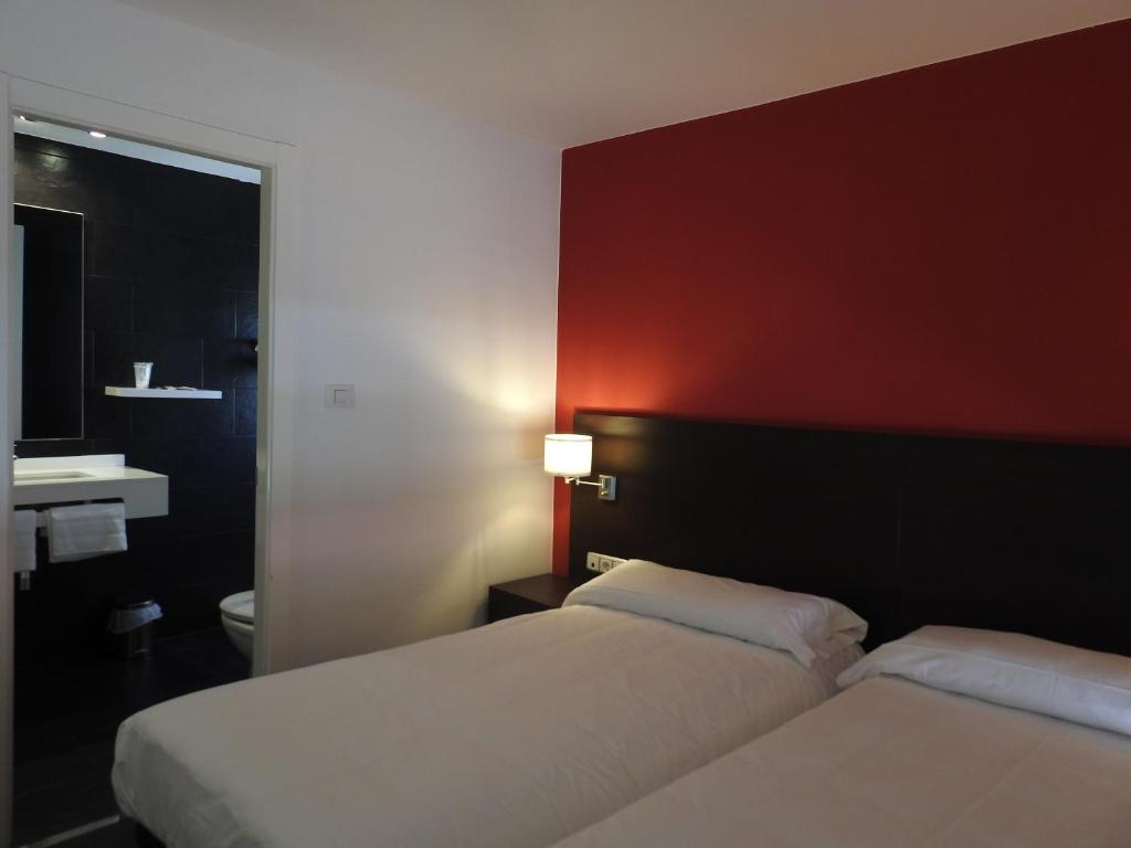 Postel nebo postele na pokoji v ubytování Hostal Meson de Paco