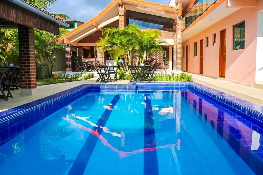 an image of a swimming pool in a house at Pousada Málaga in Porto De Galinhas