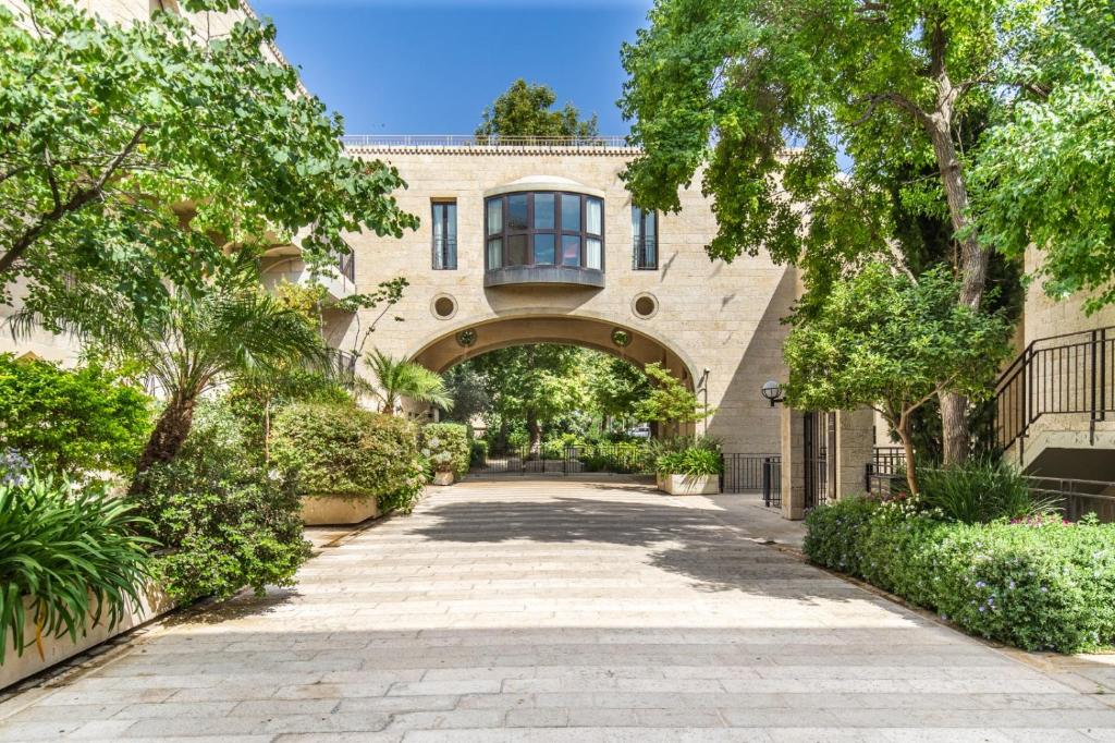 an archway leading to a building with trees at ✦Luxury 2 Bdr David's Village apartment ✦ Mamilla in Jerusalem