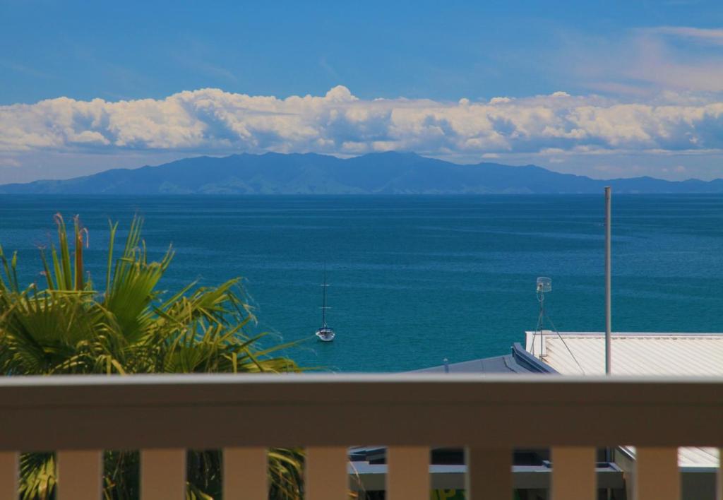 a view of the ocean from a balcony at THE WAIHEKE PAD - in the heart of Oneroa! - Be My Guest Waiheke in Oneroa
