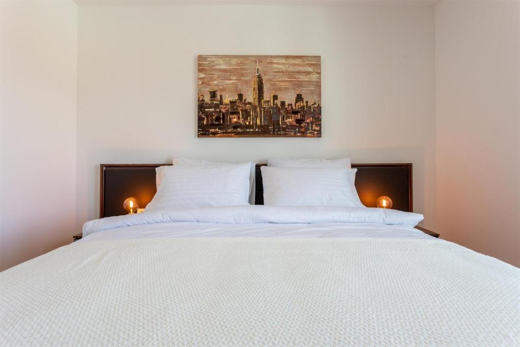 Łóżko lub łóżka w pokoju w obiekcie Villa Manhattan