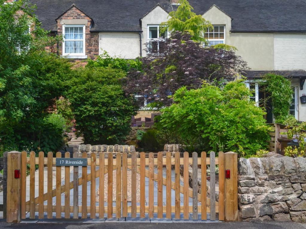 a wooden fence in front of a house at 17 Riverside in Oakamoor