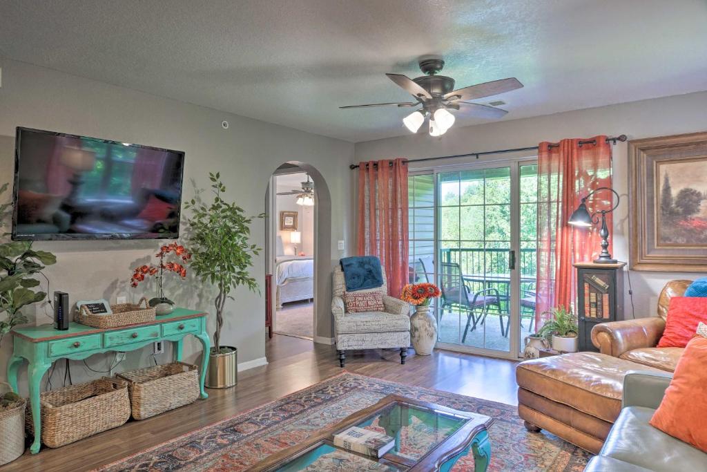 a living room with a couch and a tv at Stylish Walk-In Resort Condo Near Downtown Branson in Branson