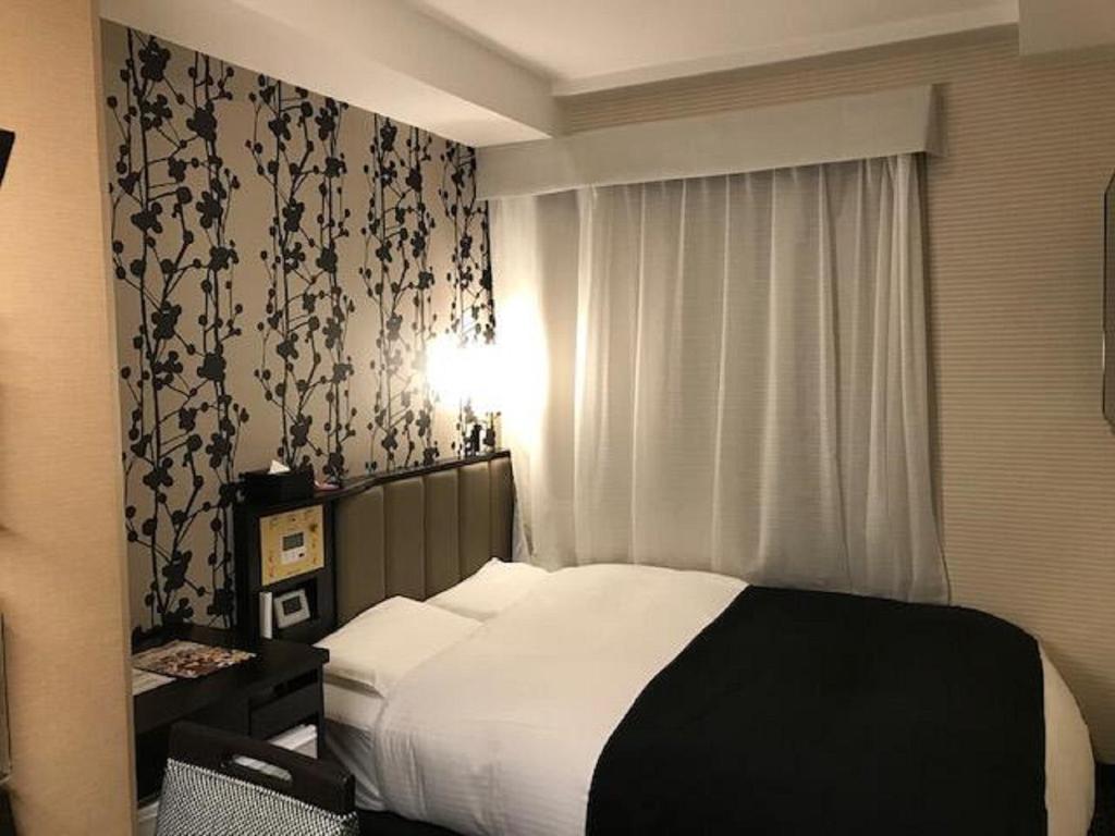 
A bed or beds in a room at APA Hotel Akihabaraeki-Denkigaiguchi
