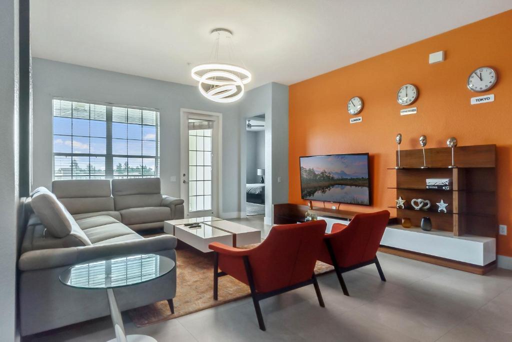 a living room with a couch and a table and chairs at Vista Cay in Orlando