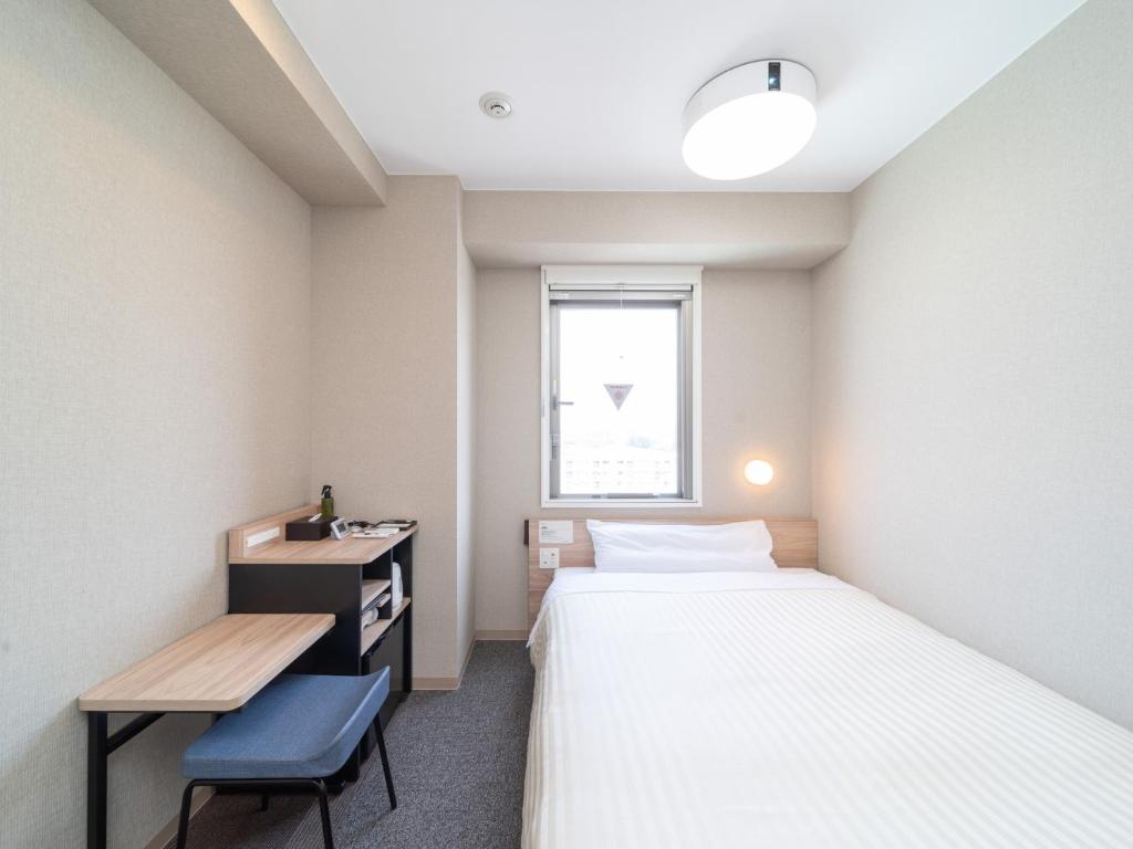 Postel nebo postele na pokoji v ubytování Super Hotel Iyo Saijo