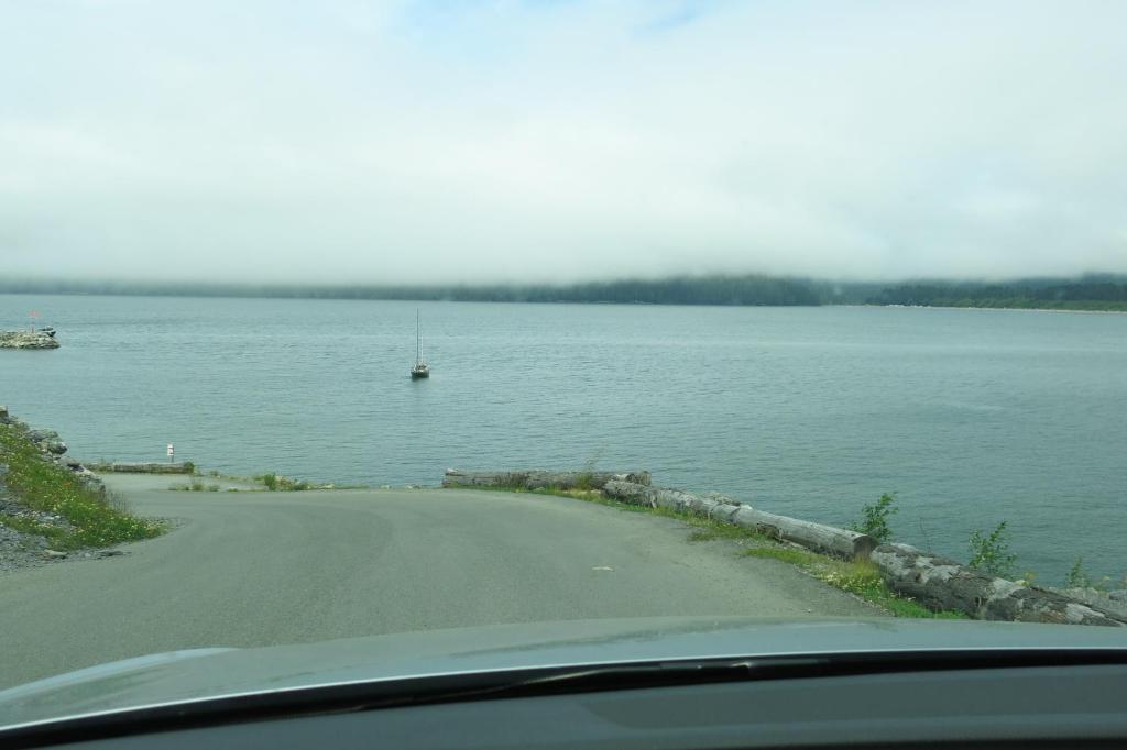 a road next to a large body of water at A Shack In The Woods in Port Renfrew